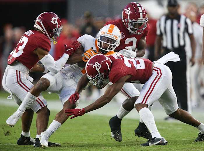 Tennessee Volunteers wide receiver Velus Jones Jr. (1) is stopped by Alabama Crimson Tide defensive back Malachi Moore (13) and defensive back Josh Jobe (28) during the first half at Bryant-Denny Stadium.